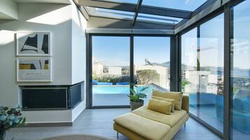 Villa | Living area | 60-inch flat-screen TV with satellite channels, plasma TV, DVD player