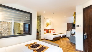 A hotel room with two beds, a small kitchenette, and a bathroom with patterned tiles. - Hoang Trinh Hotel (Da Nang)