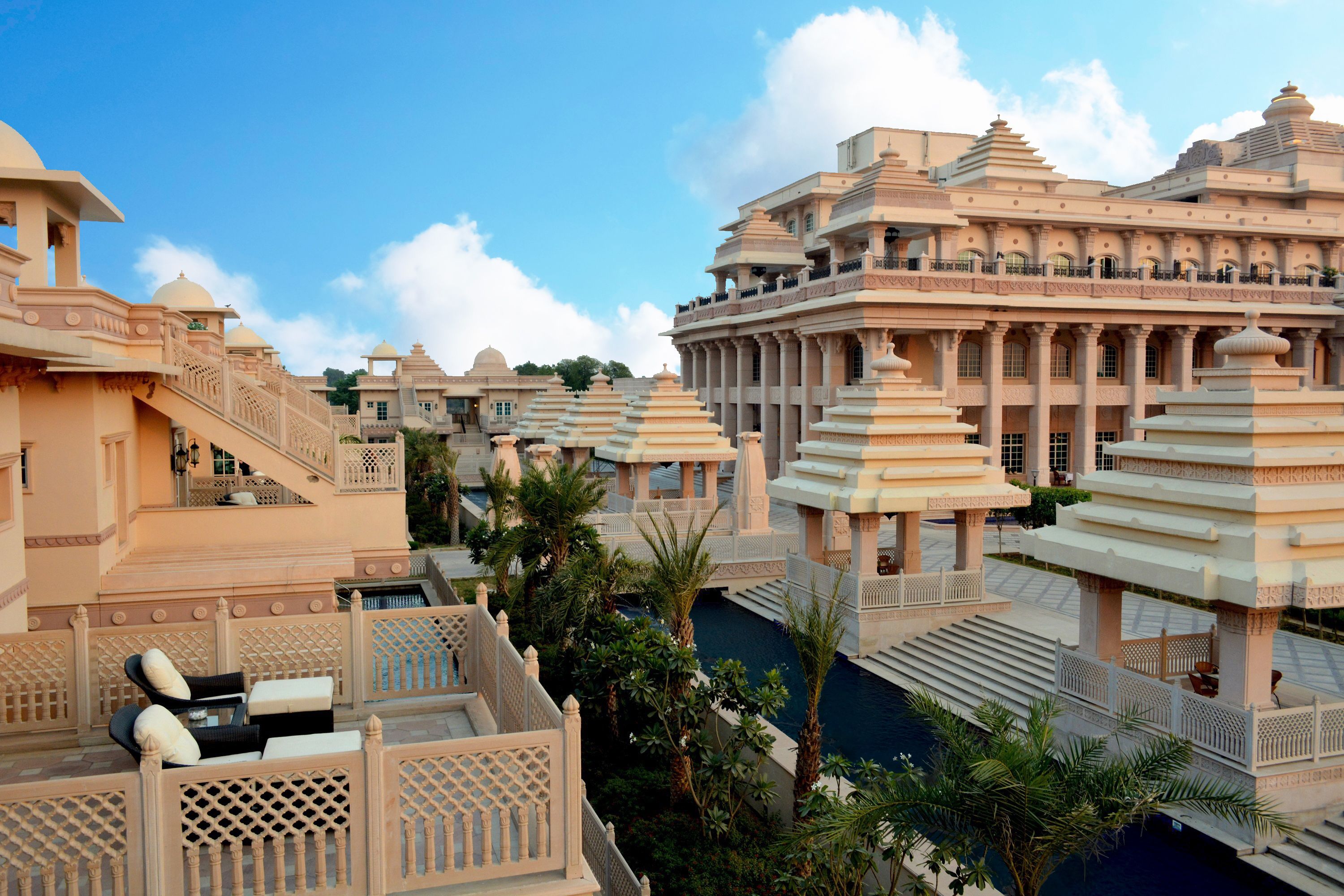 A luxurious resort with multiple buildings featuring traditional architecture, including domes and intricate designs.