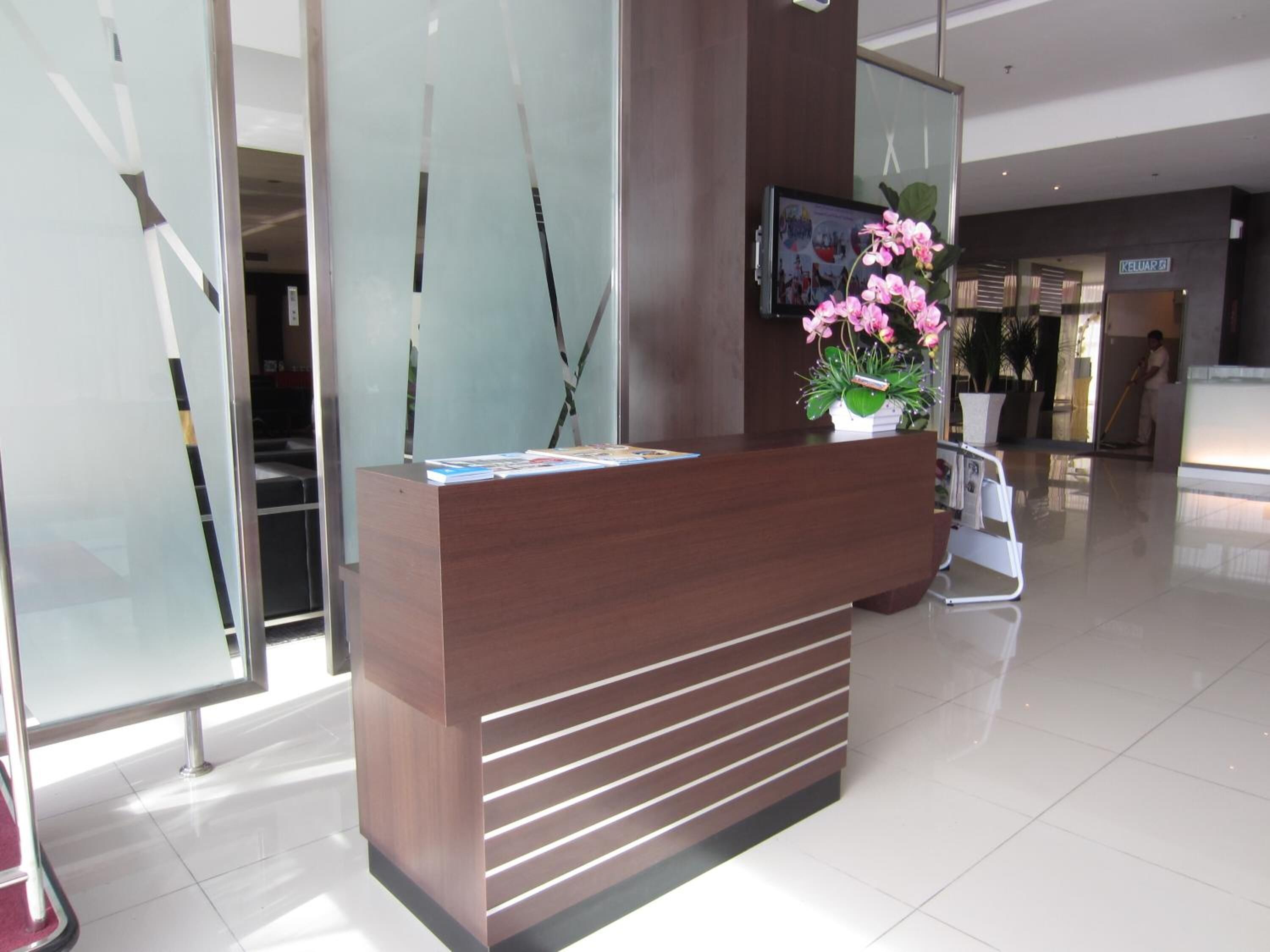 A modern reception desk with a wooden finish and horizontal slats.