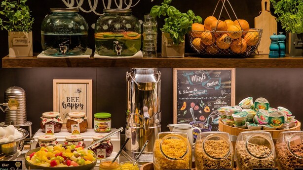 A buffet with various food options including fruit salad, cornflakes, and granola. - Motel One Prague-Florentinum (Prague)