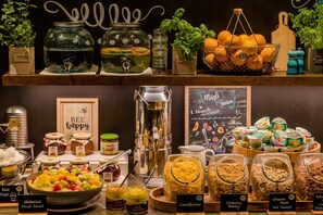 A buffet with various food options including fruit salad, cornflakes, and granola. - Motel One Prague-Florentinum (Prague)