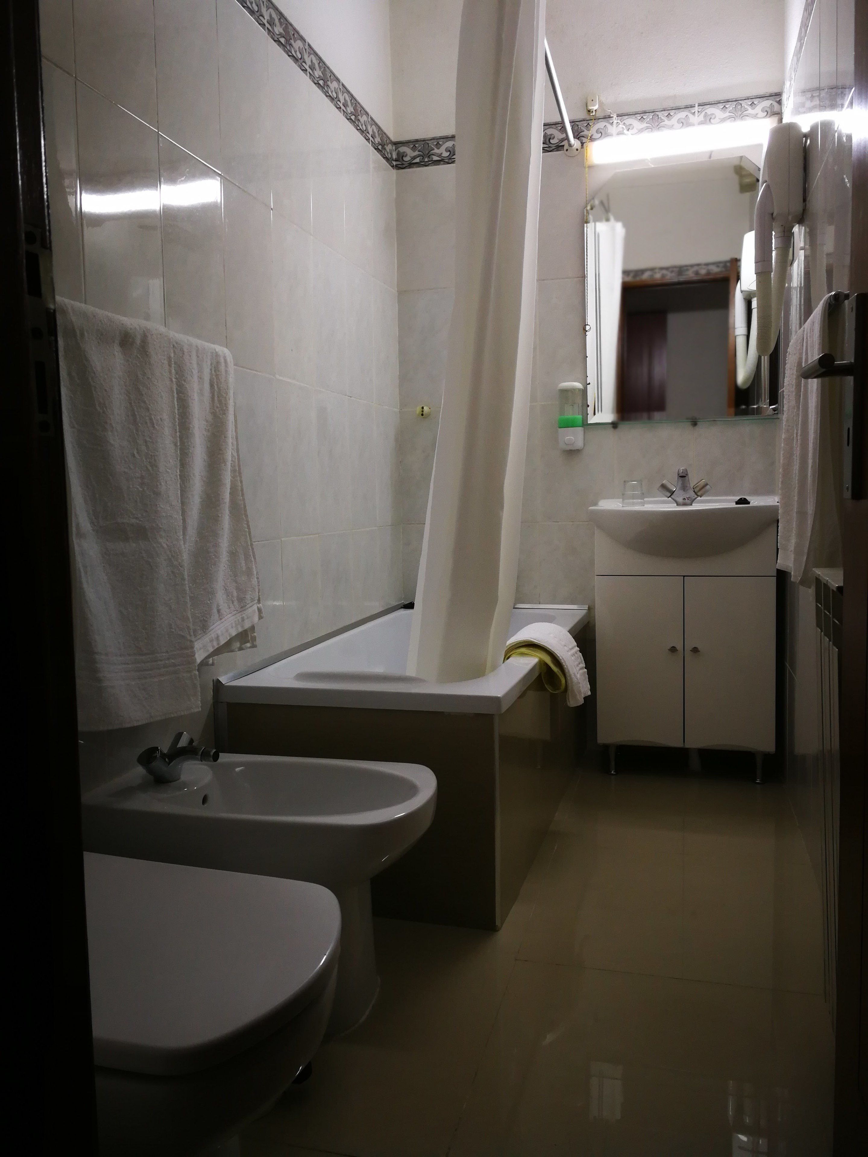 Une salle de bain avec des toilettes, un lavabo et une baignoire.