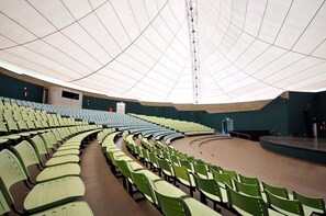 Un amphithéâtre intérieur doté de gradins et d’une scène.