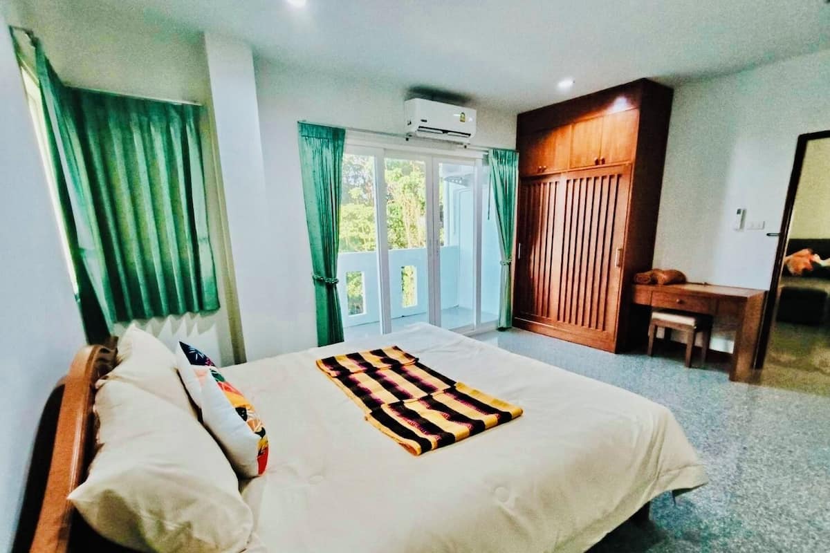 Una habitación de hotel con cama, escritorio y armario.