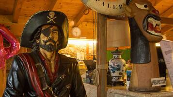 A pirate statue with a lifebuoy and a dog statue.