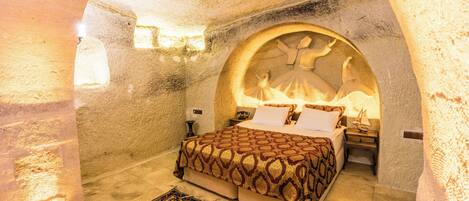 A room with a bed, a nightstand, and a wall with a circular design.