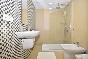 Ein modernes Badezimmer mit Schachbrettmuster an der Wand, einer Duschkabine, einer Badewanne und einem Standwaschbecken.