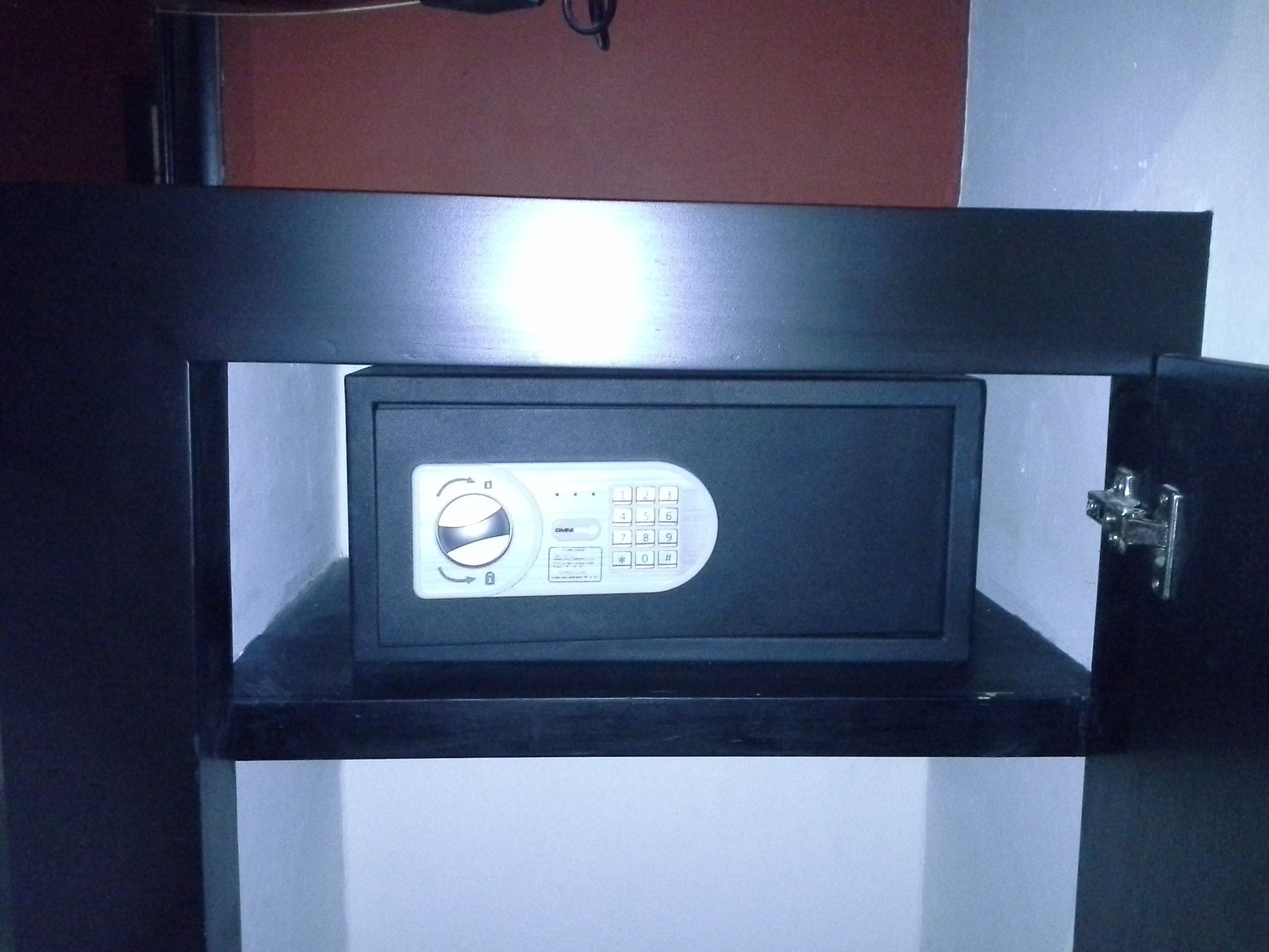 A safe with a keypad and a lock mechanism.