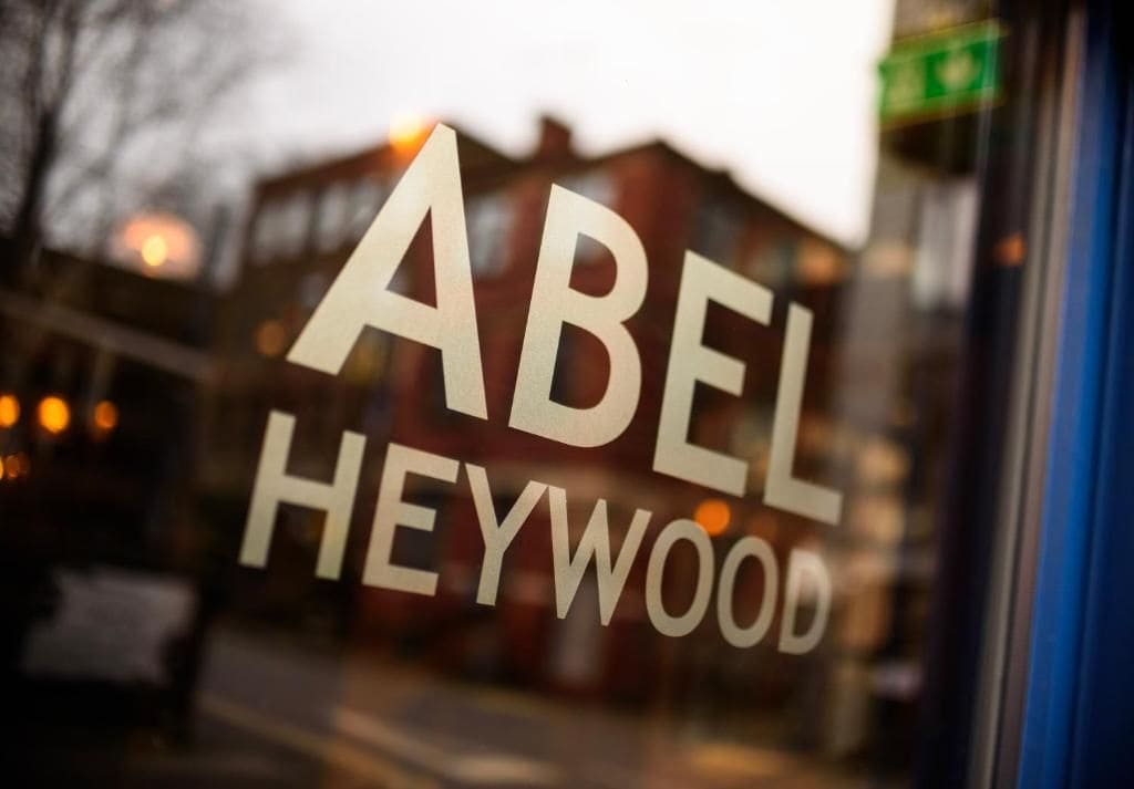 A window with the text 'ABEL HEYWOOD' in large letters.