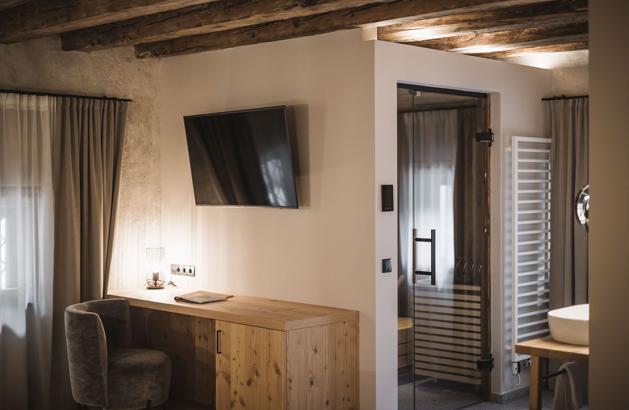 Ein modernes Badezimmer mit einem Holzlagerfläschchen, einem großen Spiegel und einer Toilette mit Duschvorhang.