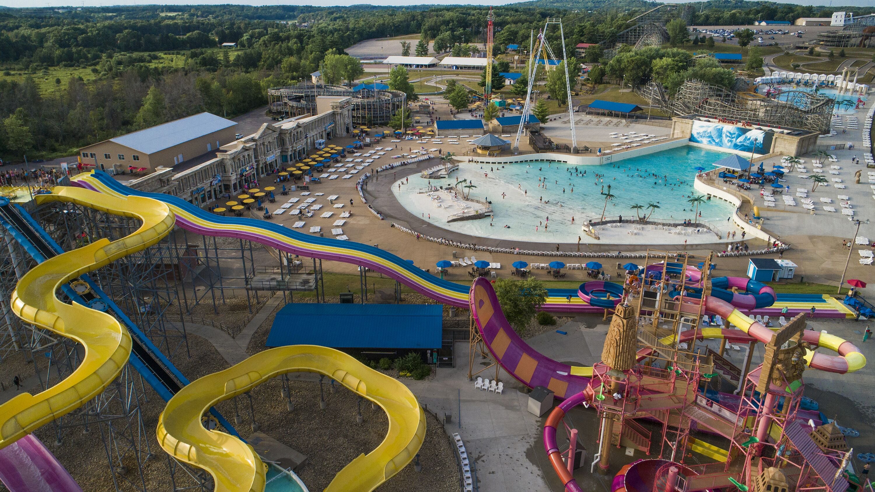 A water park with multiple slides and a large pool area.
