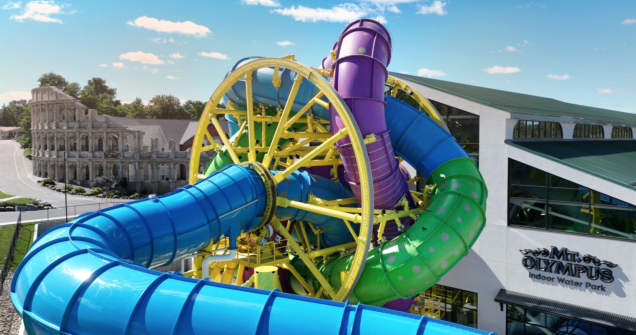 A water park with a large Ferris wheel and a blue water slide.
