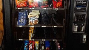 A vending machine stocked with various snacks and drinks. - Econo Lodge Mansfield (Mansfield)
