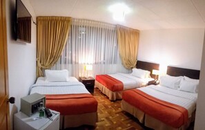 Standard Quadruple Room, 1 Bedroom | Premium bedding, down comforters, minibar, in-room safe - Casa Coliving Day 121 (Bogotá)