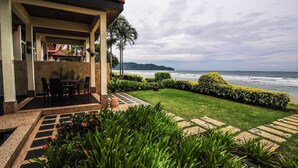 A coastal property with a patio, outdoor seating, and a view of the ocean. - Borneo Beach Villa & Suite (Kota Kinabalu)