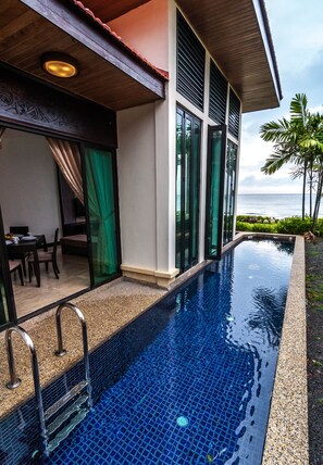 A modern hotel with a swimming pool, large windows, and a view of the ocean. - Borneo Beach Villa & Suite (Kota Kinabalu)