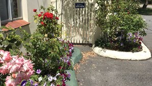 A gated entrance with a sign reading "Navarra Beach House." - Havana Villas (Emu Point)