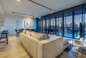 Three bedroom Skyhome | Living area | 55-inch flat-screen TV with digital channels, TV - Arena Apartments by CLLIX (South Brisbane)