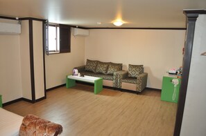 Deluxe Double Room | Living area | Flat-screen TV