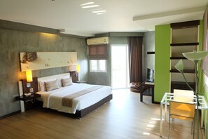 Relax in comfort with a large bed, flat-screen TV, and desk workspace.