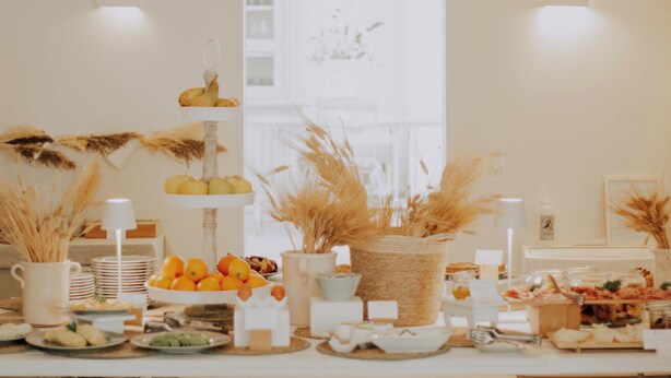 Una mesa de buffet con diversos alimentos y detalles decorativos.