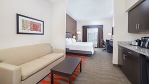 A hotel room with a sofa, a bed, a desk, and a kitchen area. - Holiday Inn Express & Suites Glasgow by IHG (Glasgow)