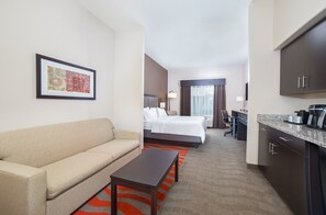 A hotel room with a sofa, a bed, a desk, and a kitchen area. - Holiday Inn Express & Suites Glasgow by IHG (Glasgow)