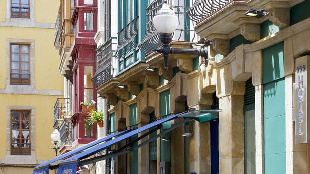 A building with multiple balconies, a street lamp, and a sign for "Hotel Iberico." - Hotel Santa Rosa, Blue Hoteles (Gijon)