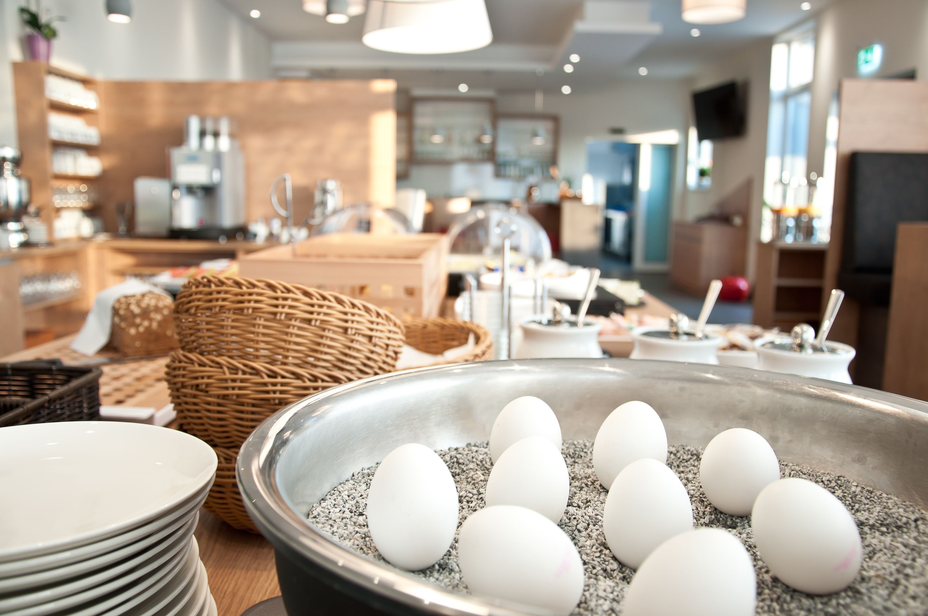 A kitchen area with a bowl of eggs and various kitchen utensils.