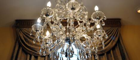A chandelier with multiple lights and crystal decorations.