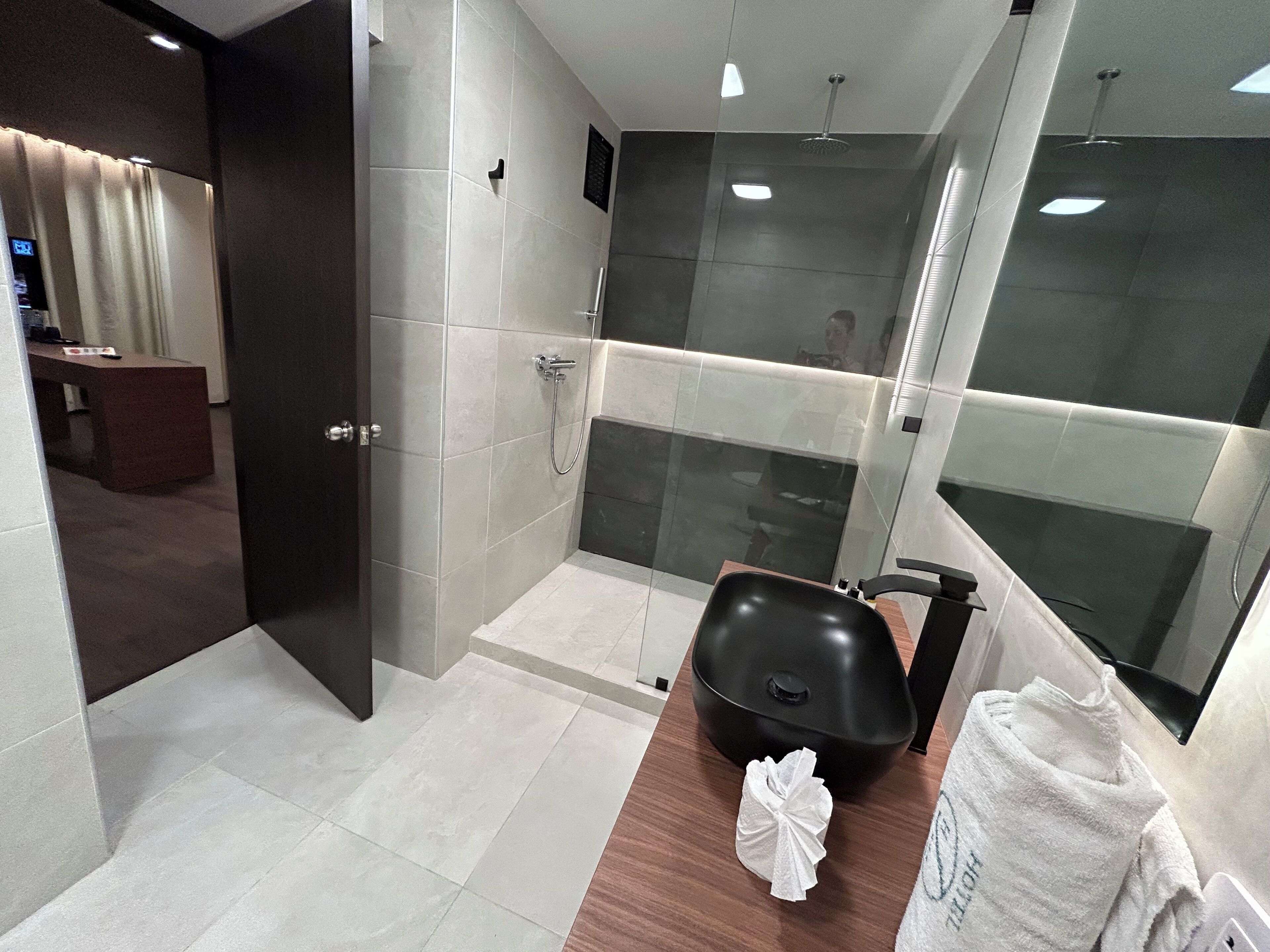 superior studio suite | bathroom | shower, hair dryer, towels, soap