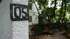 A house number '05' on a textured wall. - Corail Suites (Petionville)