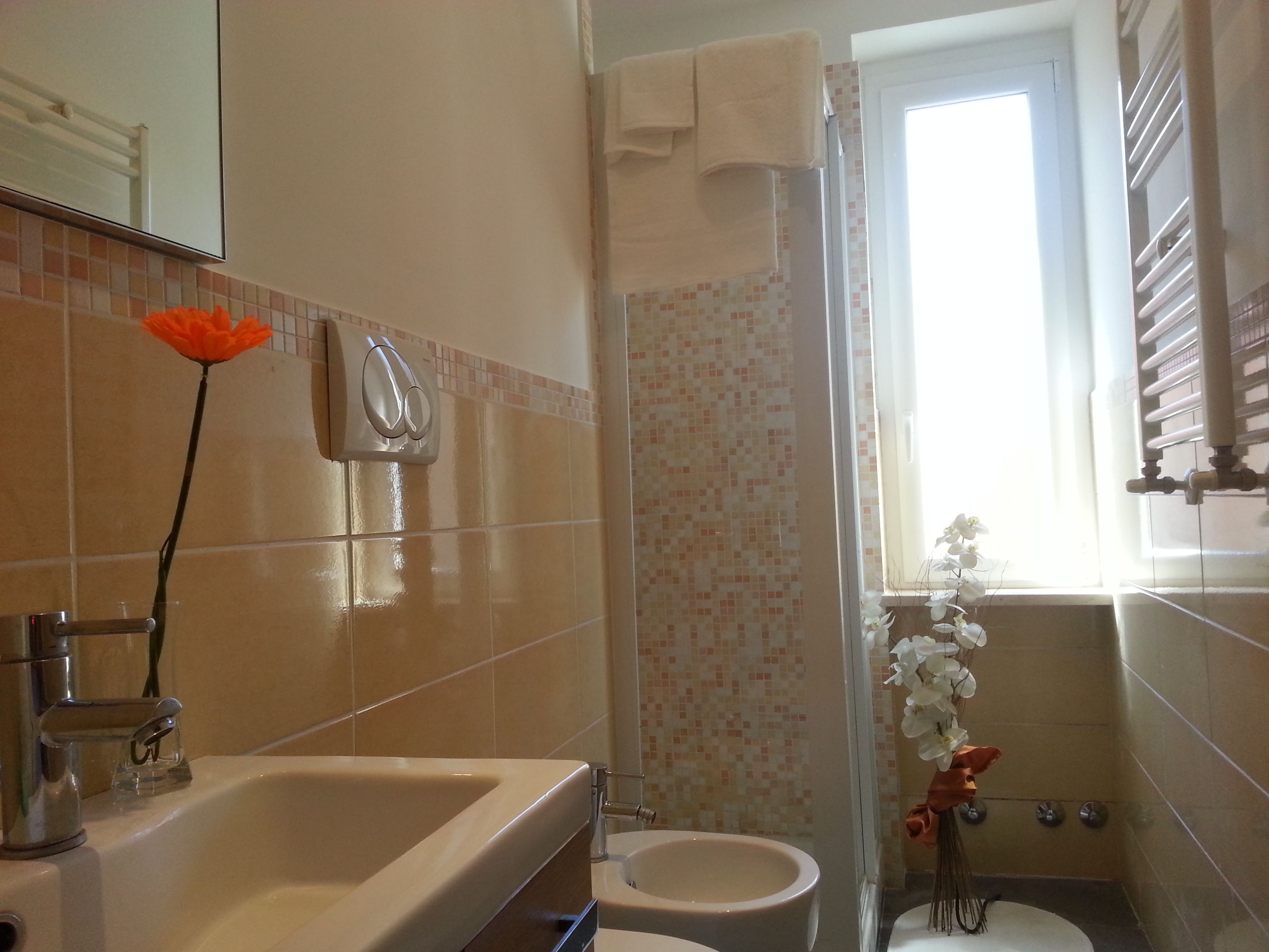 A bathroom with a bathtub, toilet, and shower.