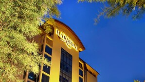 A hotel with a prominent "HARRIS" sign, large windows, and a well-lit entrance. - Harmoni Suites Hotel (Batam)