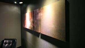A modern interior with a wall-mounted abstract painting, a leather chair, and recessed ceiling lighting. - 2 Heaven Hotel (Busan)