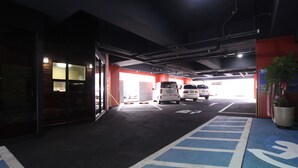 A parking garage with white cars parked in designated spaces. - G7 Hotel (Busan)
