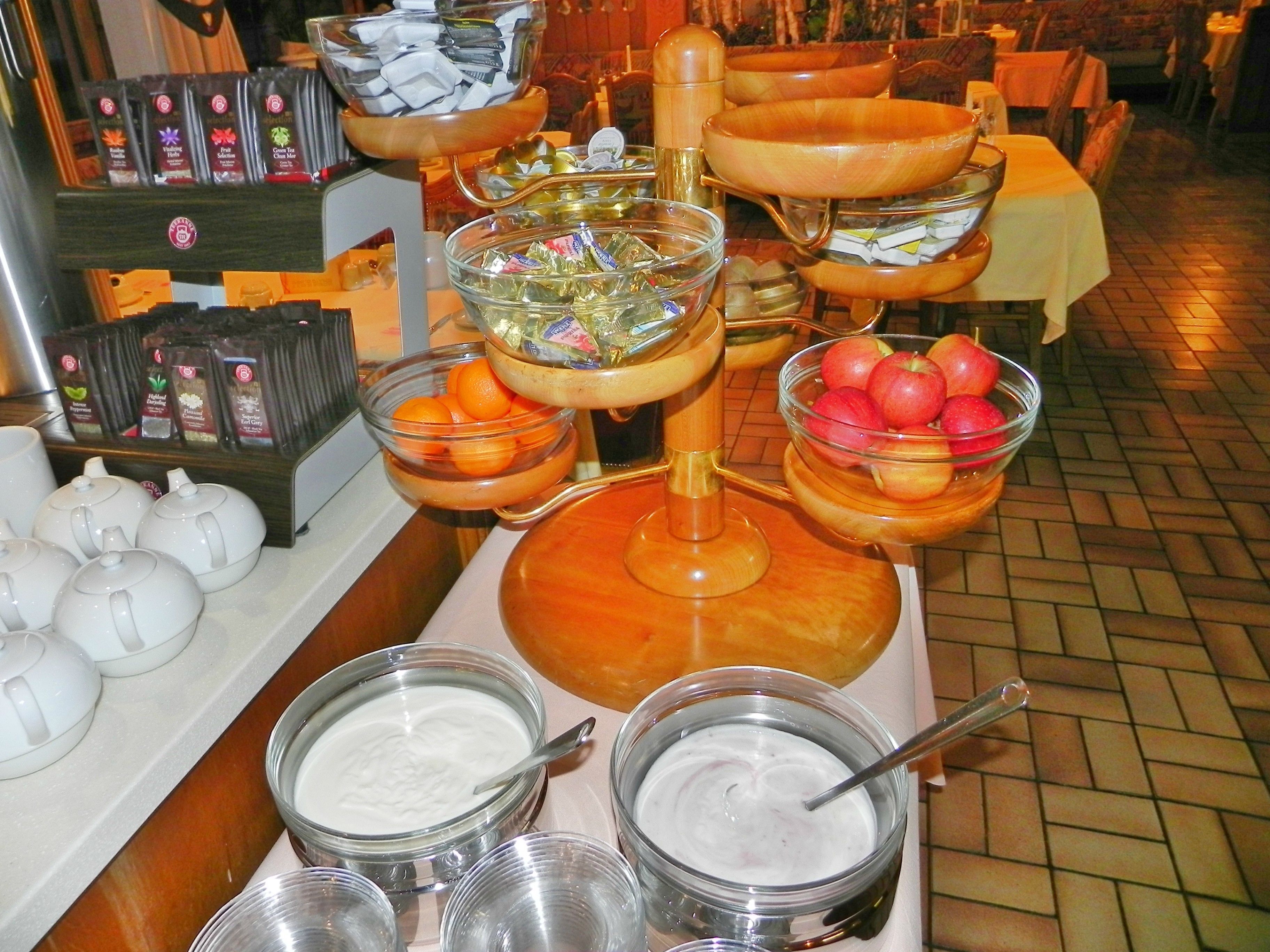 A buffet setup with various food items and condiments.