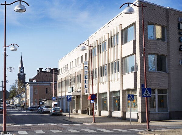 A hotel with a modern facade, large windows, and a visible entrance.
