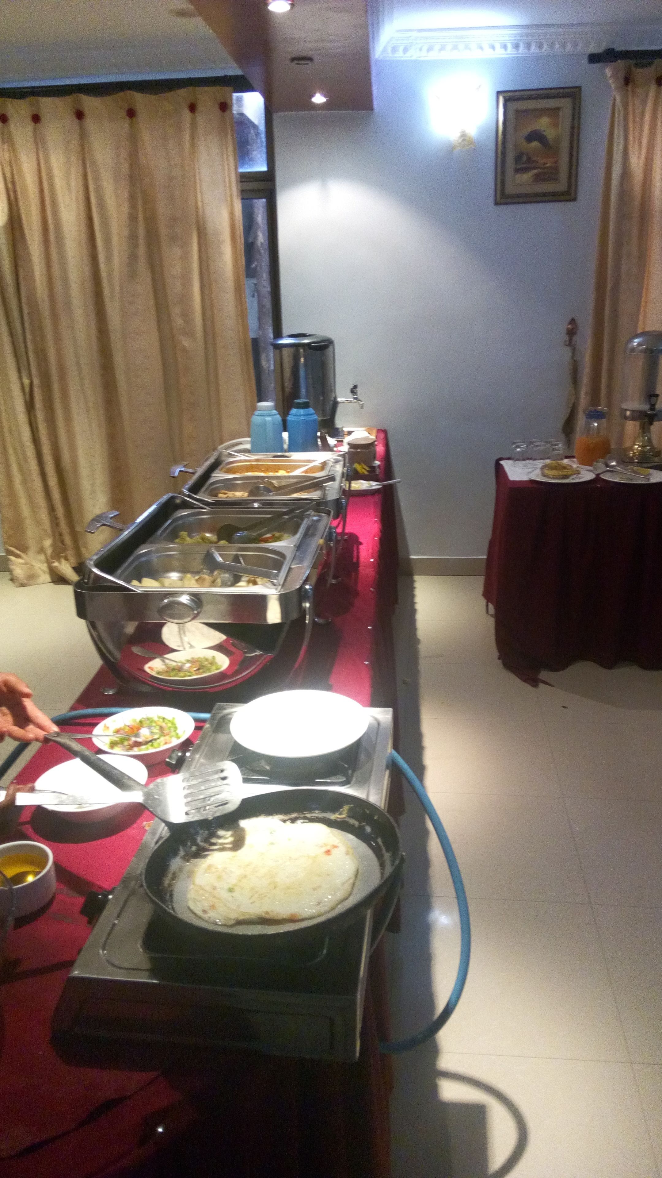 A buffet setup with various food items and a water dispenser.