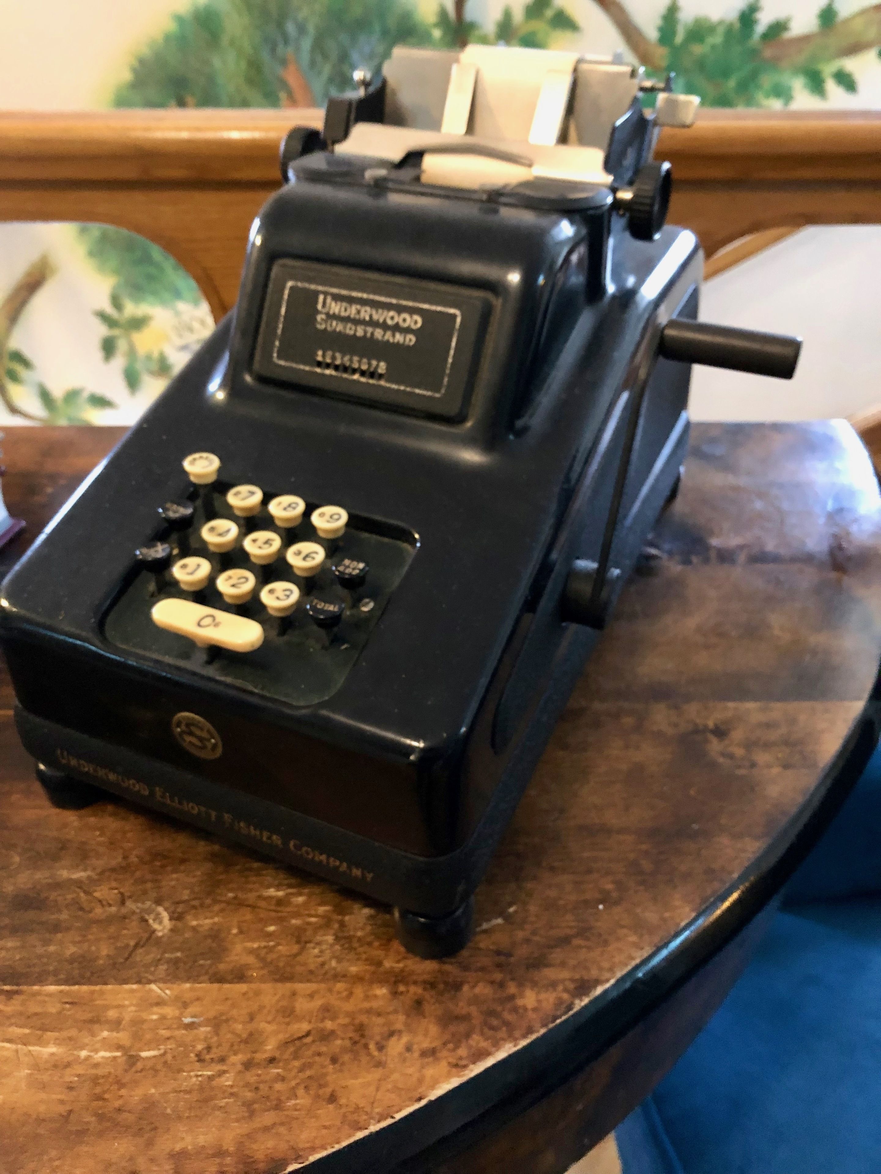 A vintage Underwood typewriter on a wooden table.