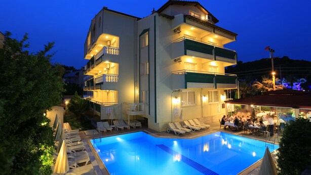 A modern hotel with a swimming pool, multiple balconies, and outdoor seating areas. - Amaris Apartments (Marmaris)