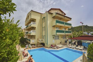 A hotel with a pool area, multiple balconies, and a view of the surrounding landscape. - Amaris Apartments (Marmaris)