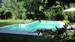 A rectangular swimming pool with two lounge chairs and a small deck area. - Angelo di Caneva (Chacras de Coria)