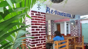 A restaurant with a brick facade and a sign that reads "Restaurante." - Hotel Miramar - Hostel (Santa Marta)