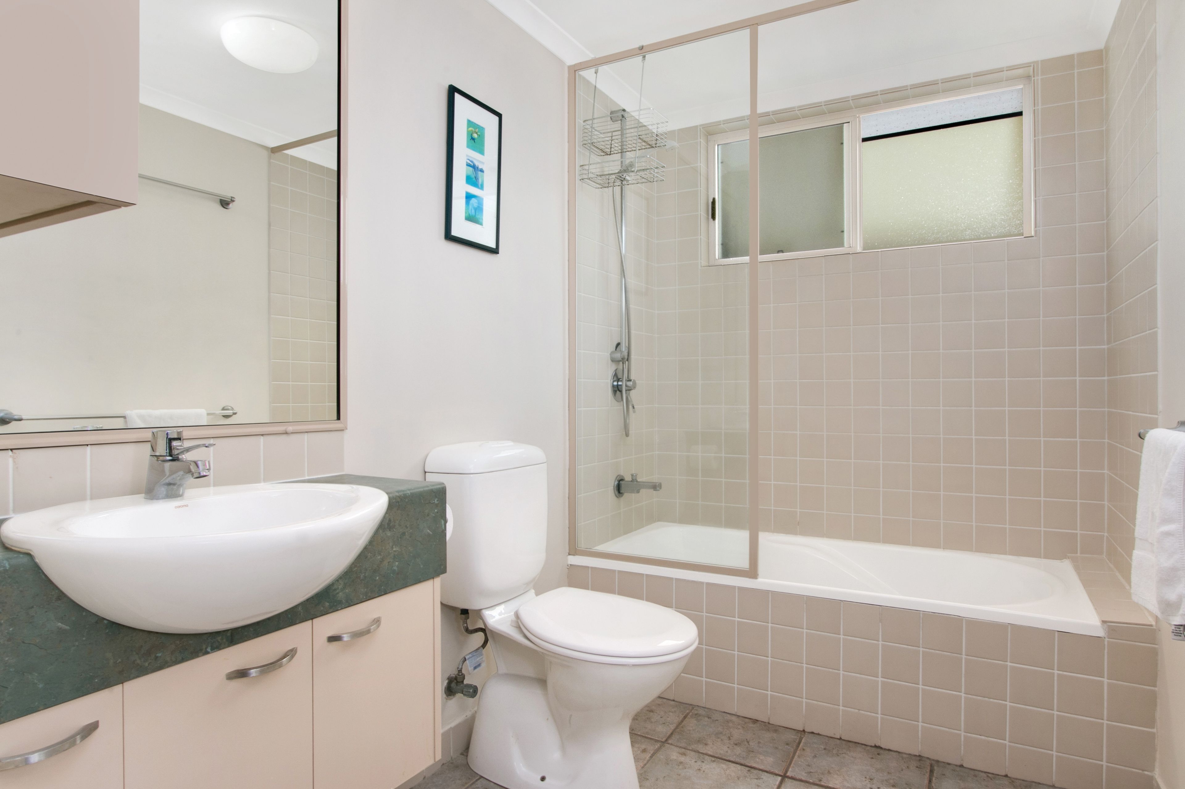 A bathroom with a sink, toilet, and shower.