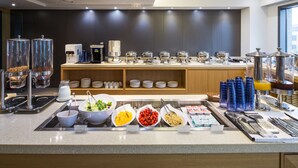 A buffet setup with various food items and beverages. - Hotel Denim (Seoul)