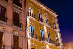 A multi-story building with ornate balconies and large windows, likely a hotel or residential building. - Hotel Flora (Cagliari)