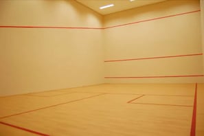 A squash court with red lines marking the playing area.