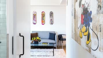 A modern living room with a large wall mural, a sofa, and a coffee table.